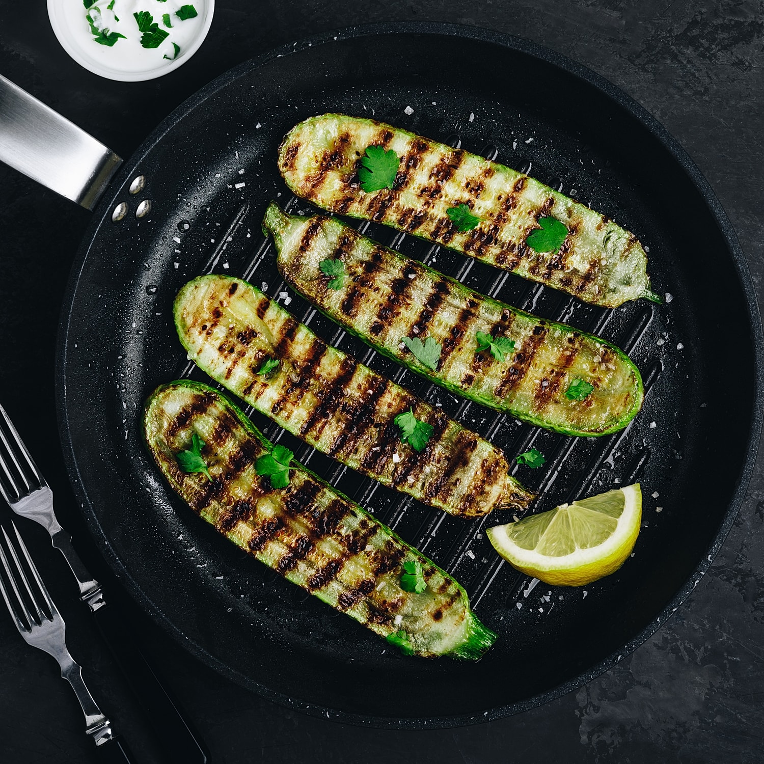 Grilled zucchini with herbs and lemon garnish