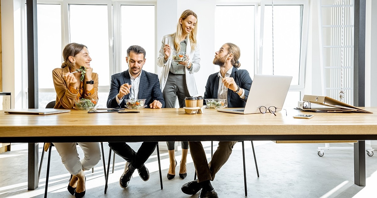 Business meeting with colleagues enjoying lunch together.