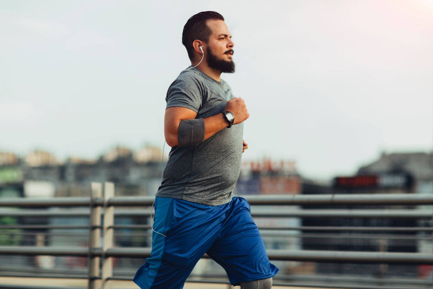 Man jogging outdoors in athletic wear.