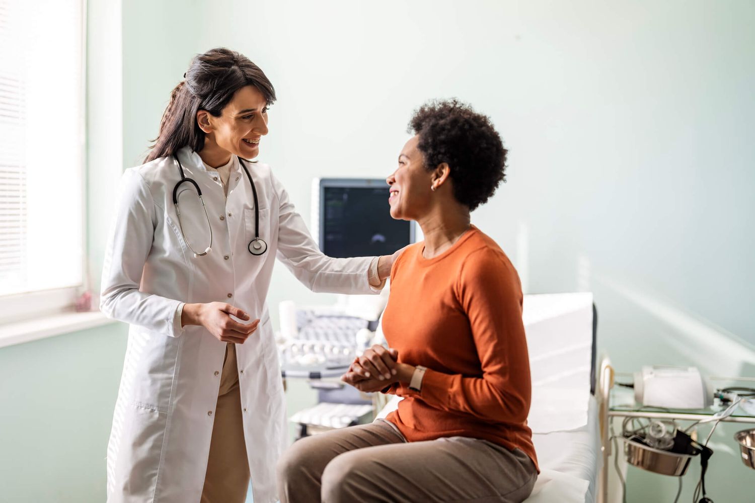 Doctor comforting patient in medical office setting