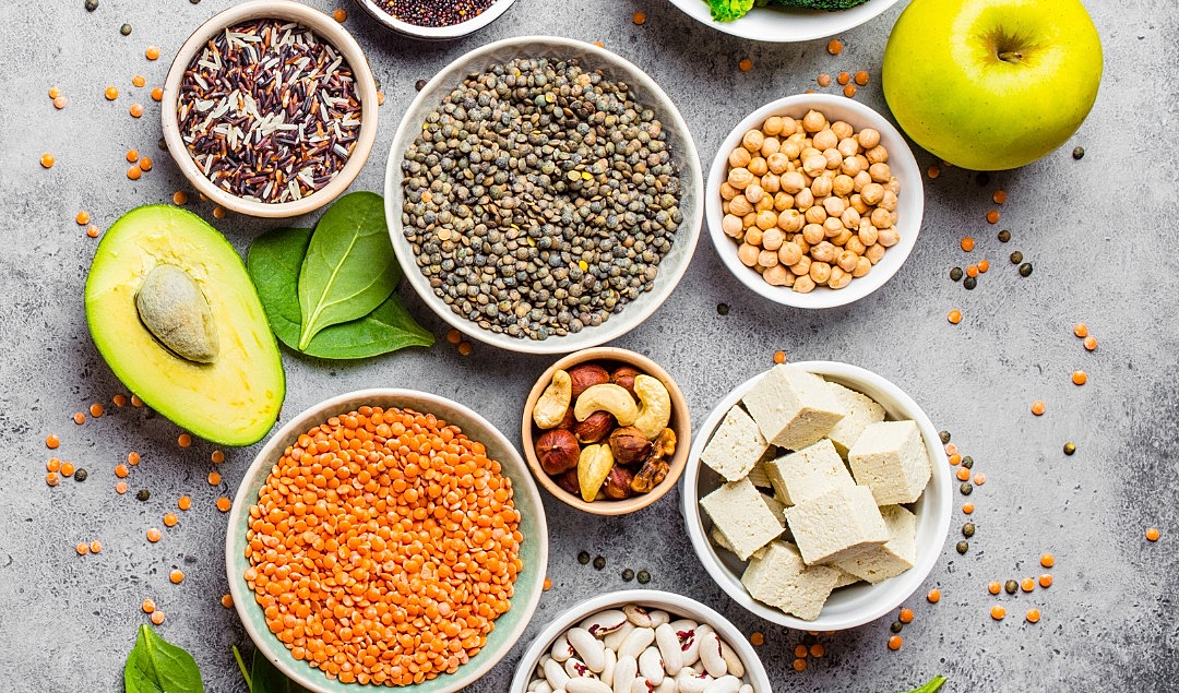 Colorful fruit platter with pancakes and tea.